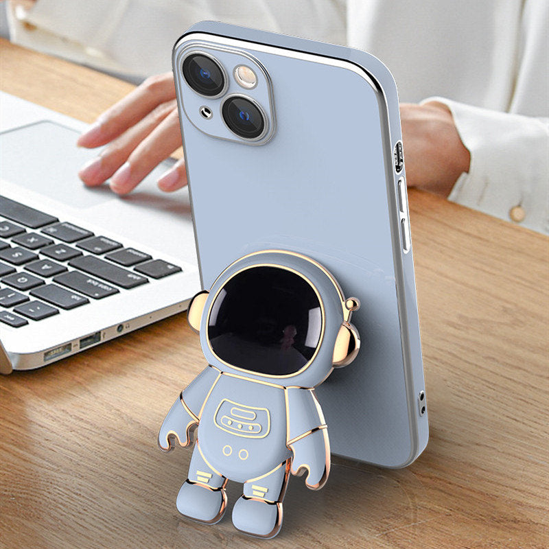 3D Astronaut Phone Case Anti-Drop Electroplating Bracket in Blue on top of wooden desk
